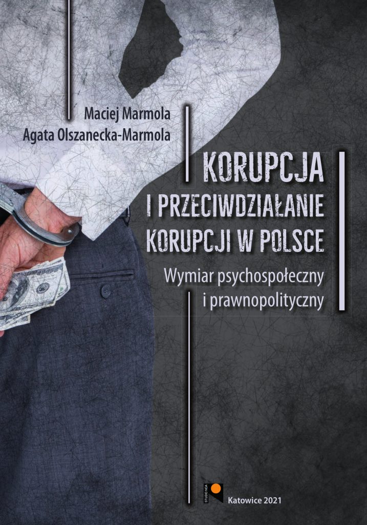 okładka książki przedstawia osobę w kajdankach trzymająca banknoty