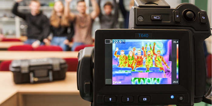 A group of happy people and a thermal camera